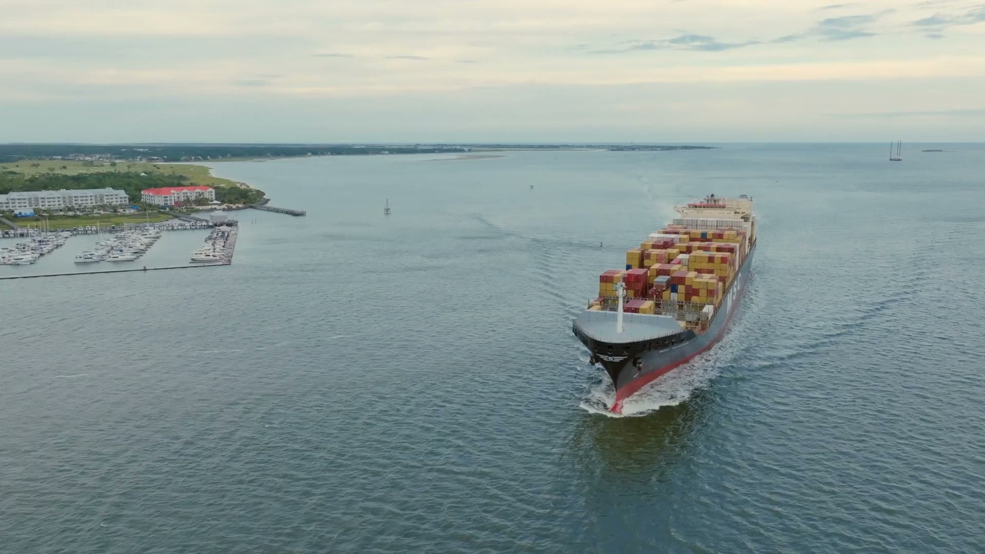 Container ship at sea heading for port (licensed stock footage)